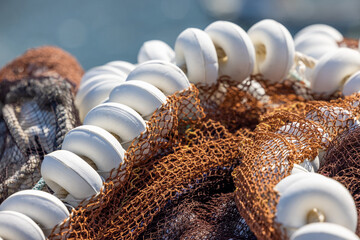 Macro image  of a brown fishing net with white beds 