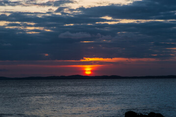 Beautiful dramatic and impressive sunset with dark and dense clouds. Spectacle of nature. Environment.