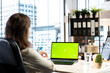 © DC Studio - Business director working in her own office with green screen, looking at device display and developing a new project idea. Female entrepreneur empowered by corporate culture.