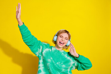 Wall Mural - Photo of adorable lovely girl wear tie dye sweatshirt singing listen songs earphones empty space isolated yellow color background