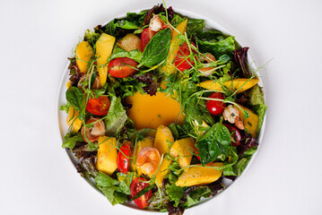 salad. shrimps, pineapples, tomatoes, lettuce leaves, micro-greens on a white background