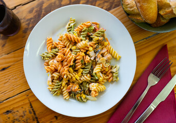 Delicious salad with pasta, seafood, corn and vegetables