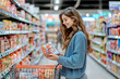 © Poj - A smiling woman shopping in a grocery store, with a merchandise in her hand on an aisle filled with packaged goods.