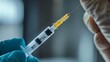 © Alpha - Macro shot of a syringe entering the skin, focusing on the medical professional's steady hand and the reflection on the metal needle