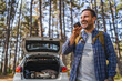 © Miljan Živković - adult man record voice message on cellphone in front car in the forest