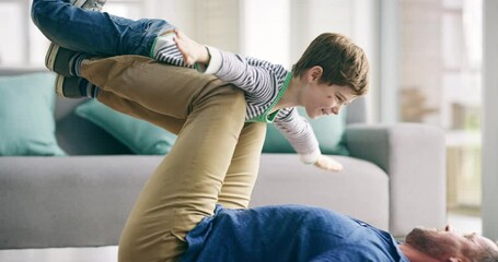 Wall Mural - Playful boy playing with his father while pretending to fly like a plane or superhero at home. Loving, fun and happy dad bonding and having fun with his kid while laughing and smiling in the lounge