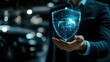© wikkie - A business person holds a holographic car shield, symbolizing automotive security and innovation.