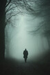 © siriwan - A man is walking through a forest in the rain