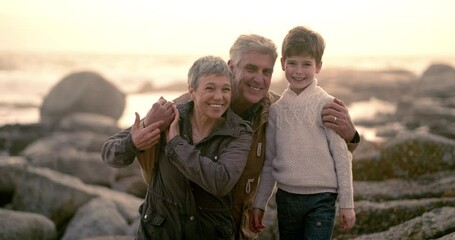 Sticker - Bonding, holiday photo with grandparents smiling with grandson for a picture at the sea on the rocks. Grandfather and grandmother taking a lovely and happy portrait with their little grandchild.