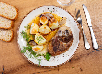 Wall Mural - Appetizing sliced lamb leg with baked potatoes and pepper, served on platter with onion