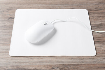 Computer mouse with mousepad on wooden desk