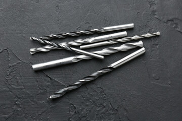 Wall Mural - Many different drill bits on black table, top view