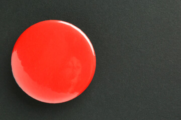 Wall Mural - Red button badge on black background, top view. Mockup for design