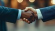 © sungedi - Close-up of two businessmen shaking hands in a formal setting.