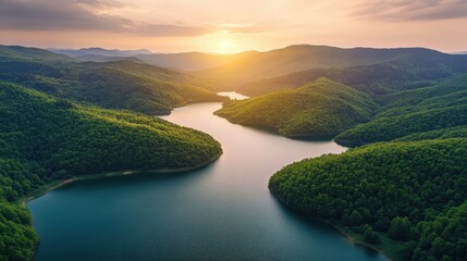 Wall Mural - Sunset Over a Serpentine Lake Surrounded by Lush Green Mountains