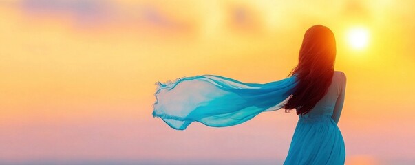 Lovely young lady waving a blue scarf in the breeze.