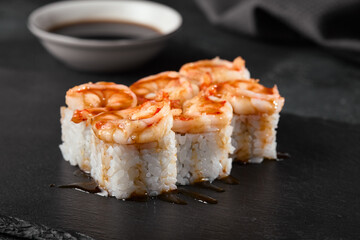 Wall Mural - Sushi Roll with Shrimp and Teriyaki Sauce on Slate Plate - High Definition Stock Image for Food Photography