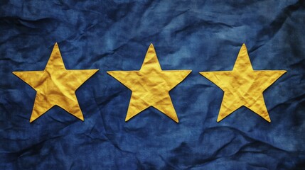Fototapete - Three yellow stars are arranged horizontally against a blue fabric background. The stars appear to be sewn onto the fabric. The fabric is wrinkled.