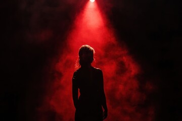 Aufkleber - In a dark room, a shadowy figure emerges under a single spotlight, enveloped by deep red and black colors, evoking suspense and fear. Generative AI