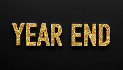 year end word lettering with glitter gold shining effect on plain black background