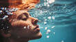 © Xingguo - A person dives underwater, closes his eyes and holds his breath, surrounded by bubbles in the clear water, with the background blurred to highlight the subject.
