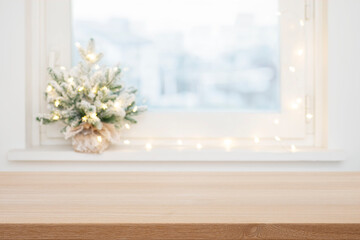 Sticker - Empty wooden table top in front of blurred Christmas decorated frosty window background