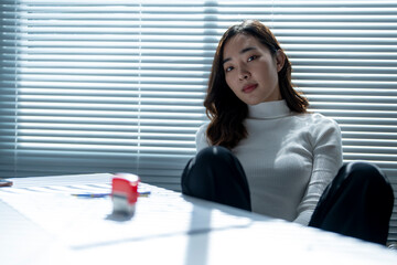 Wall Mural - businesswoman sitting at office desk taking a break