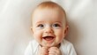© Marnee - Happy baby smiling joyfully with sparkling eyes, capturing innocence and delight in a close-up portrait.
