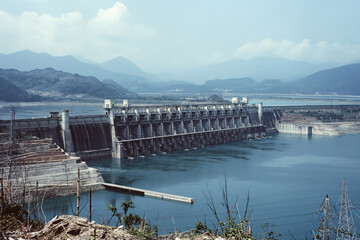 Hydroelectric dam standing tall in a mountainous landscape, showcasing the power of renewable energy generation