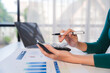 © Wicitr - Financial planning, close up of female hands using calculator and smartphone