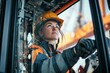 © Denis Tuev - female crane operator inside the cabin of a towering construction crane