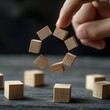 © Ace64 Studio - Agile development methodology concept. flexible developing process of business growth. agile life cycle. hand hold the wooden cubes with agile process cycle symbols on grey background and copy space.