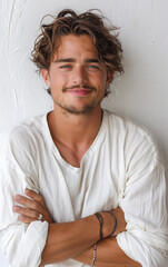 Canvas Print - A man with a beard and mustache is smiling and wearing a white shirt. He is posing for a picture and has his arms crossed