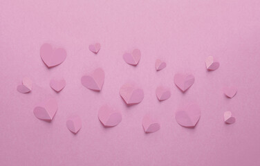 Wall Mural - Paper-cut yellow hearts on a pink background. Love, romantic concept. Creative layout. Top view