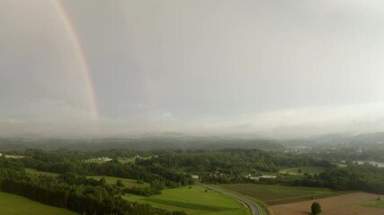 Wall Mural - magical rainbow over a misty countryside landscape. enchanted forests, rainy day, wet road, rolling 