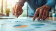 © AssanAI.Studio - Hands Pointing at Business Charts and Strategies