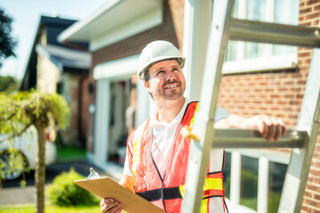 inspector or engineer with ladder checking the building structure and house roof specifications.