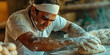 © Lila Patel - Baker's Touch: A baker meticulously shapes dough, their deft movements and satisfied expression on full display.