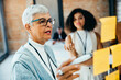 © (JLco) Julia Amaral - Senior businesswoman facilitating a creative strategy session with colleague
