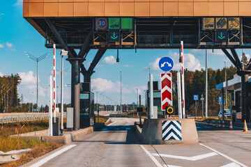 Toll station. Crossing toll road gates at sunny summer day