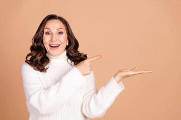 Poster - Photo of lovely surprised woman wear white stylish jumper introduce empty space isolated on beige color background