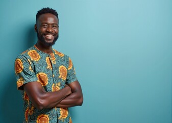 African American man with cheerful expression wearing floral shirt against teal background with copy space