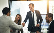 © ThurstanJam/peopleimages.com - Smile, business people and shaking hands in meeting for deal, b2b partnership or investment agreement. Happy group, collaboration or handshake for acquisition, success or financial support in office