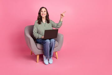 Wall Mural - Full length photo of charming positive woman wear striped shirt writing modern gadget showing empty space isolated pink color background