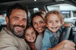 © Milos - A happy family of four enjoys a joyful moment inside their car, with both parents and children smiling enthusiastically, embracing togetherness and adventure.