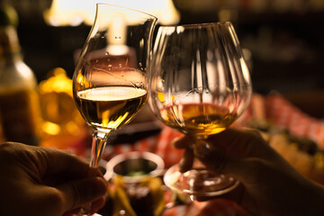 toast with glass of whisky in a bar