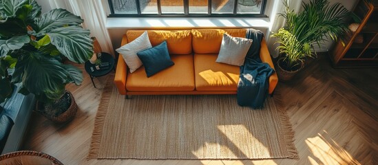 Wall Mural - Yellow couch in a modern living room with large windows and sunlight streaming in.