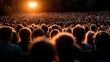 ©  Jovaduplex - The audience is seated, watching an event outdoors with a sunset view in the background, encapsulating the experience of communal engagement and the ambiance of natural light.