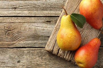 Sticker - Ripe juicy pears on wooden table, top view. Space for text