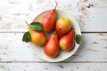 Sticker - Ripe juicy pears in bowl on light wooden table, top view